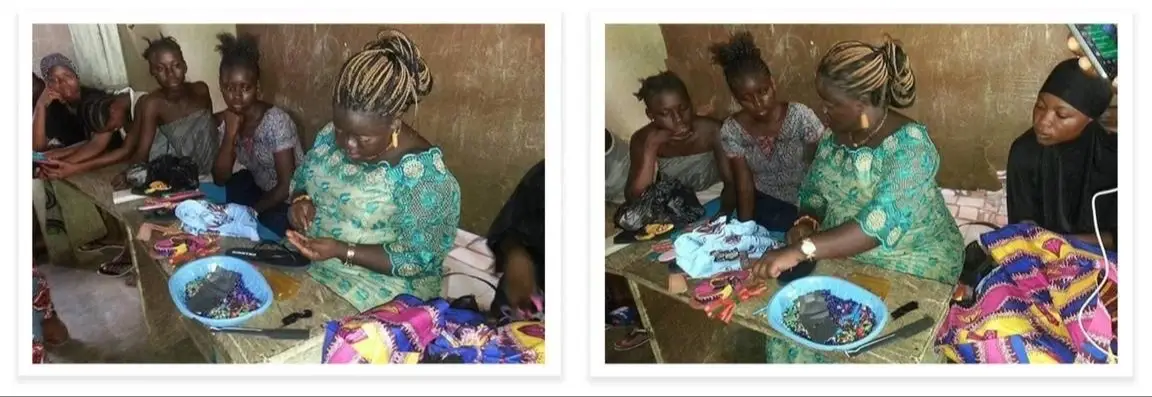 A young woman shows a group of girls how to make something.
