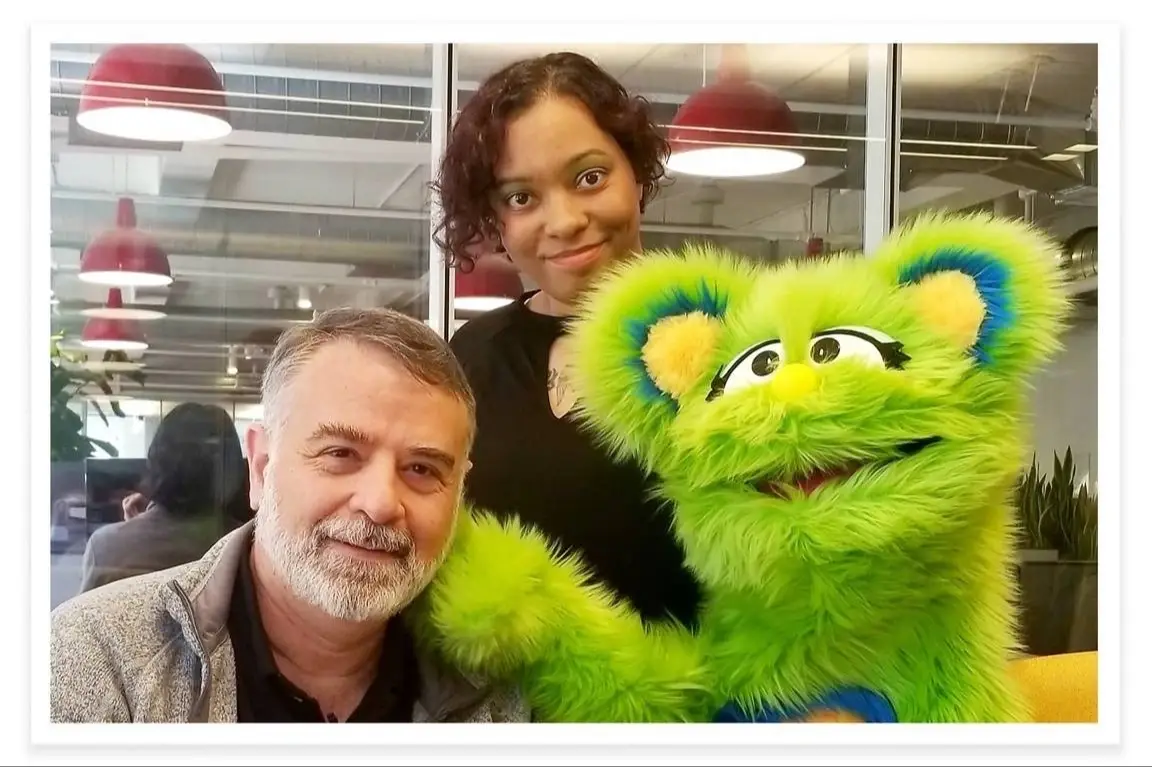 Sarah McKenzie, Ami Dar, and Ida the puppet pose for a photo together.