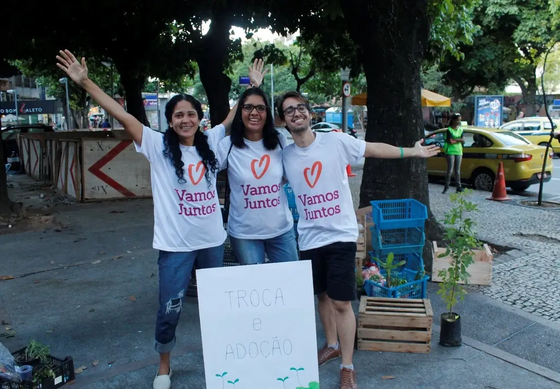 three people standing and smiling