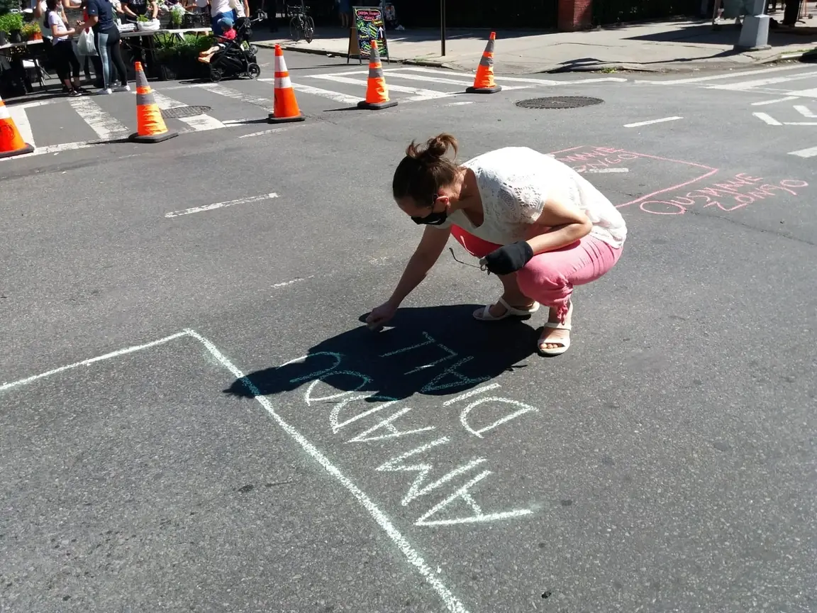 A woman makes protest art.