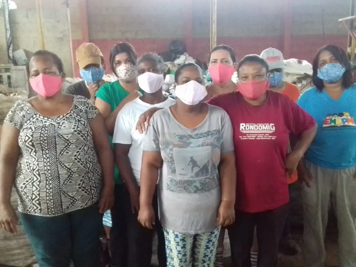 A group of people wearing masks pose for a photo.