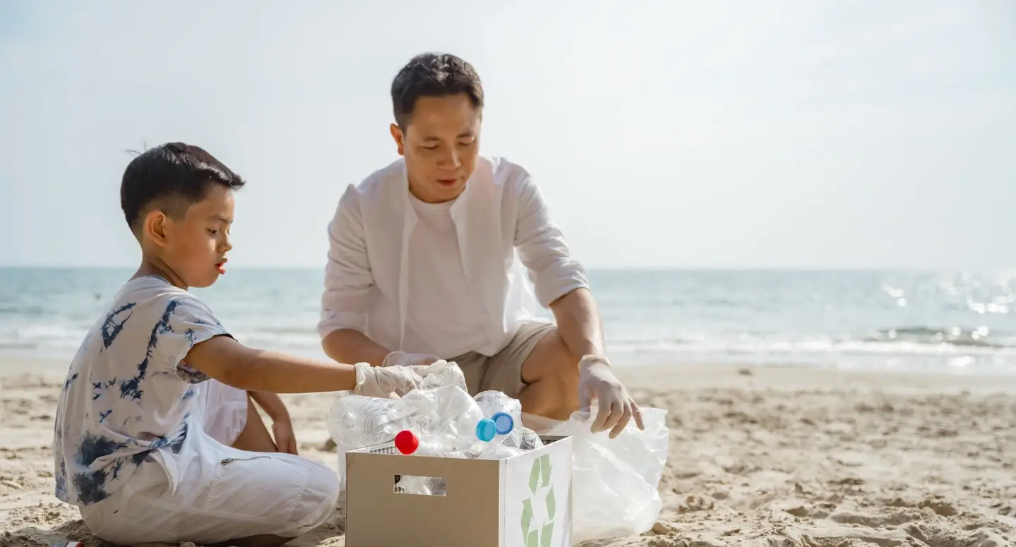 Father and son volunteer for a beach clean-up