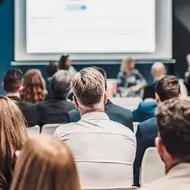An audience gathered for a speaker session at an association event.