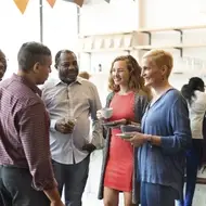 group of colleagues network at a nonprofit event in a city.