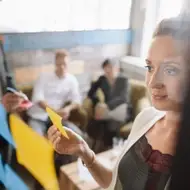 group of co-workers making a list at work