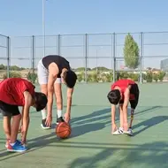 high school volunteer leads basketball camp for kids