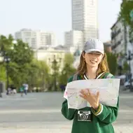 Photograph of a kind city with a tourist looking at a map