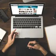 Photo of a person sitting at a computer