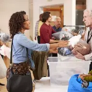 a volunteer donates gently-used clothing at her local shelter