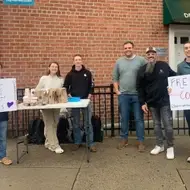 A group of individuals from Hope Community in Brooklyn, NY hand out free coffee and donuts to neighbors.