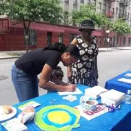 Idealist Day volunteers sign up to volunteer together at booth