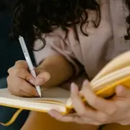 Mulher fazendo anotações em um caderno