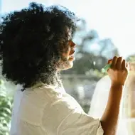 Black woman writes on the window at her office