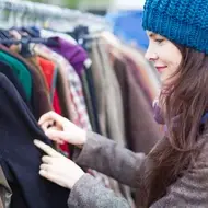 Woman smiles while volunteering at a nonprofit thrift store