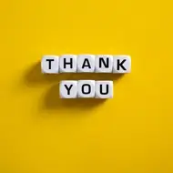 Yellow greeting card with "thanks!" written on it in yellow letter blocks