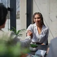 Woman shakes hand at work