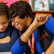 an AARP volunteer smiles with a participant in her program