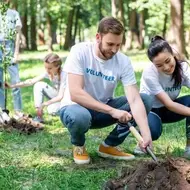 Volunteers at an environmental volunteer opportunity laugh and smile