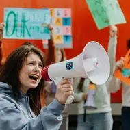 Mulher em um protesto segurando um megafone