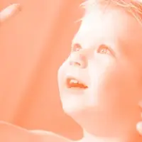 A young boy looks toward the sky.
