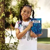 Girl holding up acting notebook