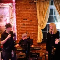 Members of the band Flash Drive, Joe DiThomas, Mike Scarpa, and Julie DiThomas performing