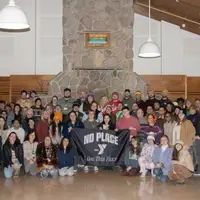 Staff group photo holding a banner for the Y This Place campaign