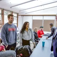Students talking with after teacher class
