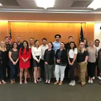 two rows of people standing in a mock courtroom