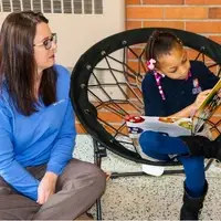 MAPSA Team member reading with an elementary student in Detroit