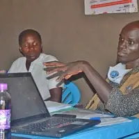 CECI Uganda Founder and Executive Director Patrick Chandiga Justine Abure meeting with local communities in Village one Bidibidi refugee settlement for establishment of the Salaam Radio
