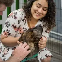 man helps introduce a potential adopter to a dog