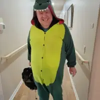 Larry is wearing an alligator costume for Halloween.