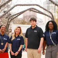 four VISTA members stand together, smiling