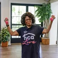 Senior woman holds up free weights