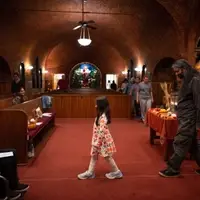 group walks a labyrinth inside a church in front of an autumn equinox altar