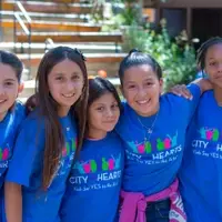 A group of five diverse City Hearts students smiling