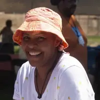 woman in sunshine smiling at camera