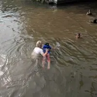Volunteer teaches the kids how to swim