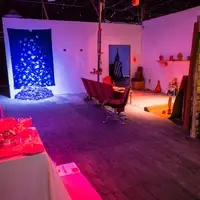 A DIY gallery with lighted zones of artwork organized by color