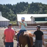 A patient on horseback during a hippotherapy session.