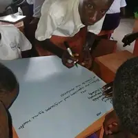 Ugandan students discussing  the dangers of cheating and bribery during exams. This shows TNYME Uganda’s commitment to mentoring youth in ethics. Volunteers can help set up and manage our GoFundMe to build a permanent school.