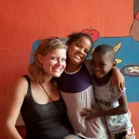 Volunteer smiling with Children