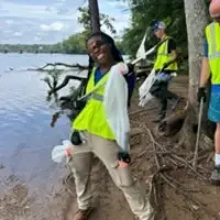 happy volunteer hold trash