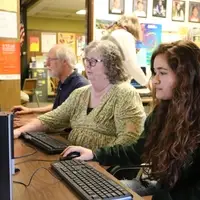 Student and ASPIRE mentor exploring online resources in computer lab