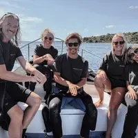Interns on the boat giving the turtle sign