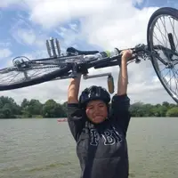 Teng holding up their bike at Como