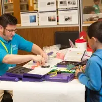 Teacher works with child on project