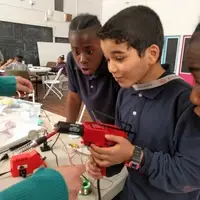 Youth using a heat gun for electronics