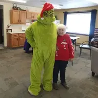 Christmas Time picture of two seniors, one in a Grinch costume and one dressed as Cindy Lou Who